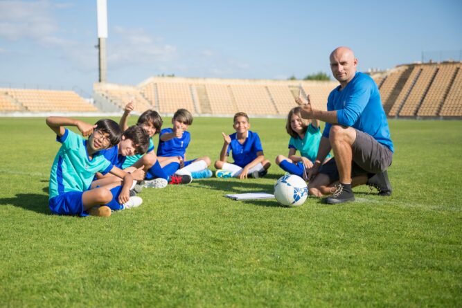 Trainer und Kinder beim Fußballtraining